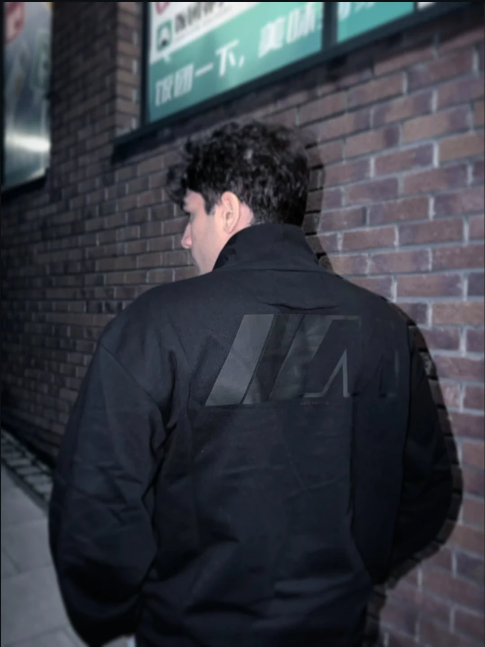 Walking down a brick-walled street at night